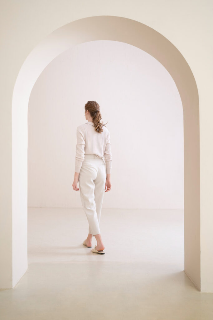 woman walking in beige empty room