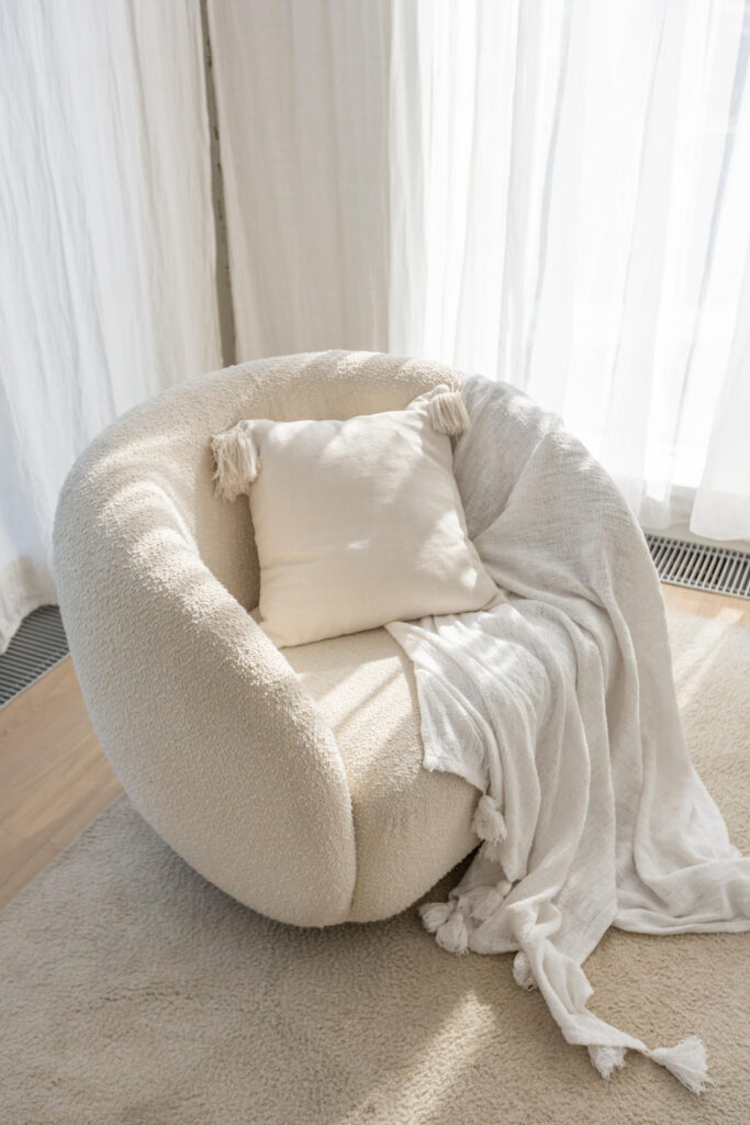 small couch in white room with pillow